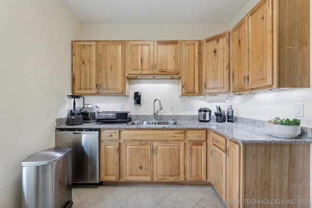 kitchen with light brown cabinetry, sink, light stone countertops, light tile patterned floors, and stainless steel dishwasher