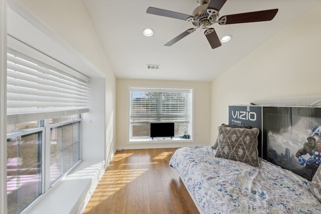 bedroom featuring ceiling fan, wood-type flooring, and lofted ceiling