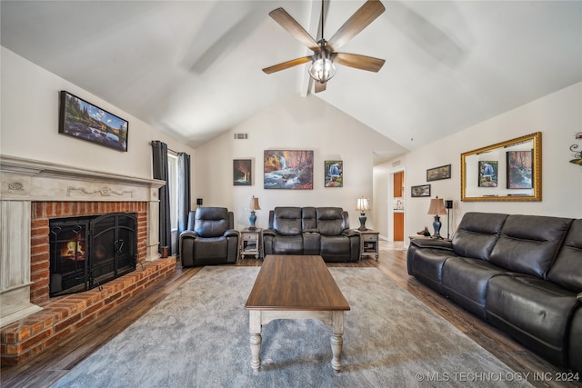 living room with lofted ceiling, a brick fireplace, hardwood / wood-style flooring, and ceiling fan