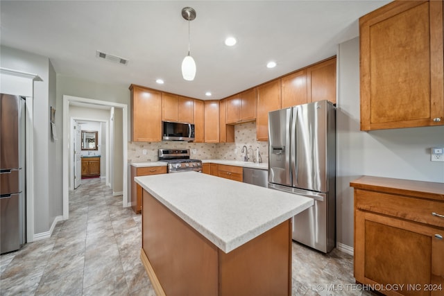 kitchen featuring a kitchen island, hanging light fixtures, backsplash, sink, and appliances with stainless steel finishes