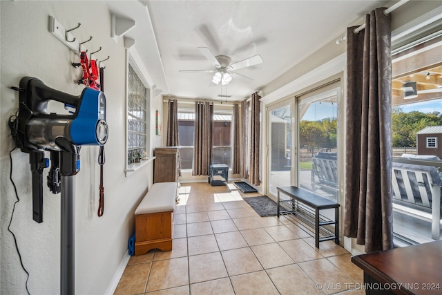 interior space with ceiling fan