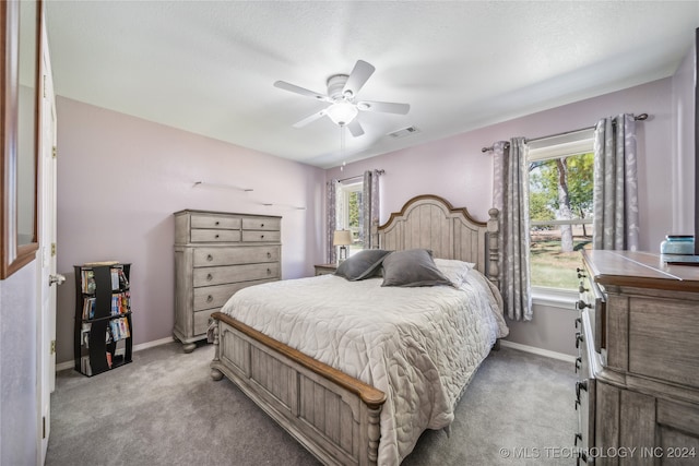 bedroom featuring ceiling fan, carpet, and a textured ceiling