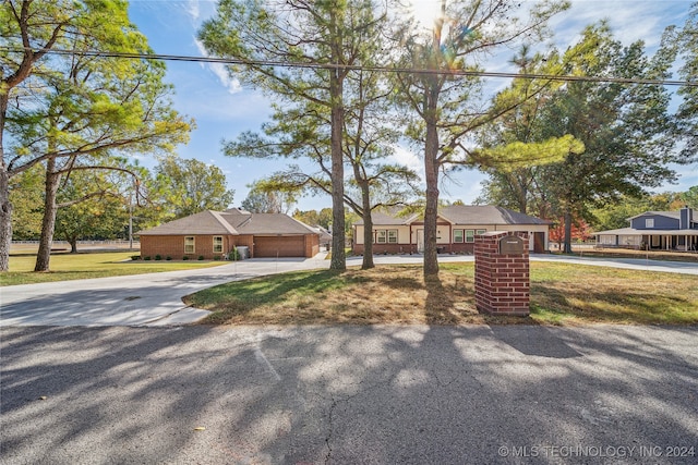 single story home featuring a front yard and a garage