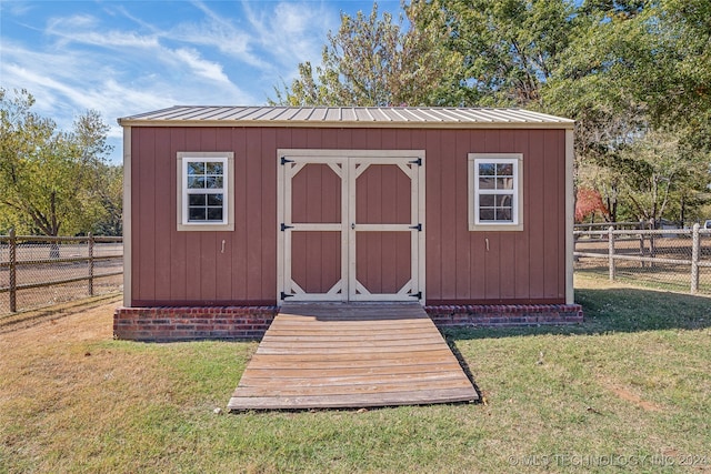 view of outdoor structure featuring a lawn