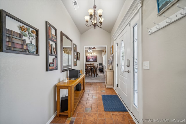 doorway to outside with vaulted ceiling and ceiling fan with notable chandelier