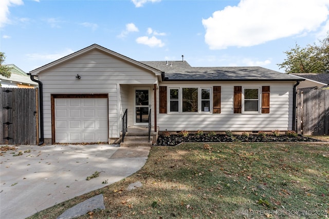 single story home featuring a front lawn and a garage