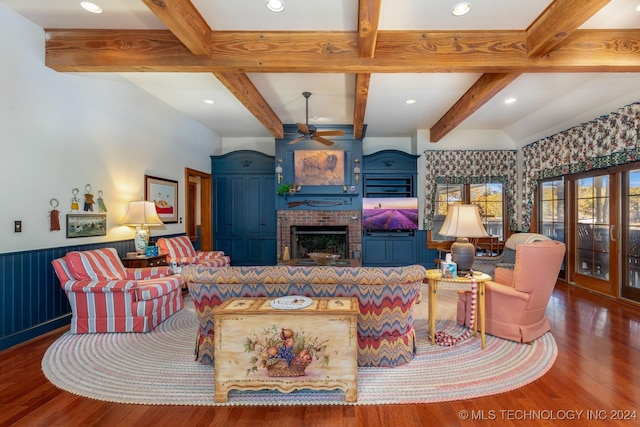 living room with ceiling fan, beam ceiling, a fireplace, and hardwood / wood-style floors