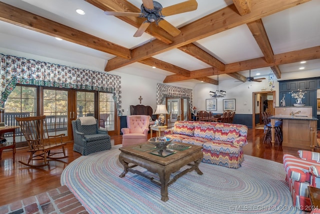 living room with ceiling fan, beamed ceiling, and dark hardwood / wood-style flooring