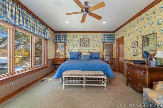 carpeted bedroom featuring crown molding and ceiling fan