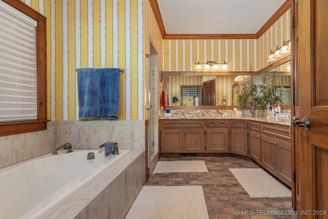 bathroom with vanity, ornamental molding, and tiled tub