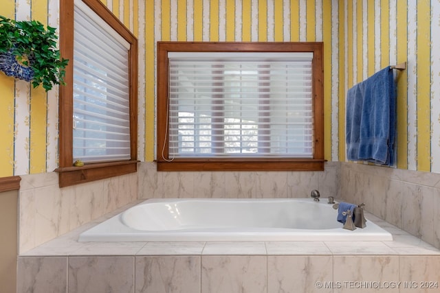 bathroom featuring tiled tub