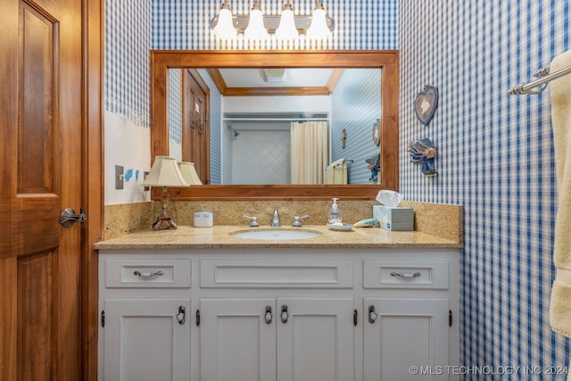 bathroom with vanity and ornamental molding