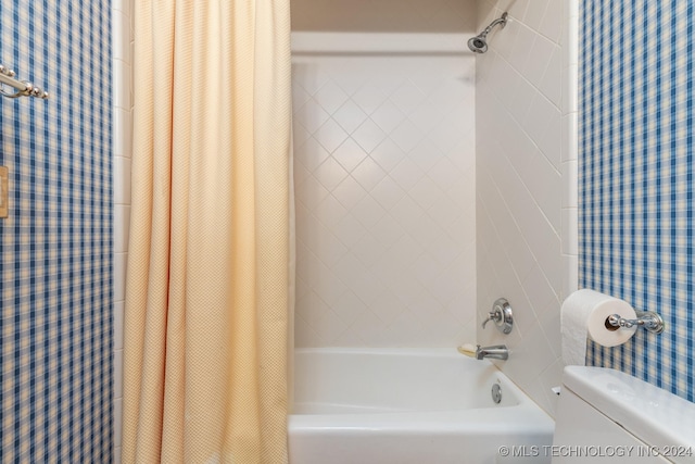 bathroom with toilet and shower / bath combo