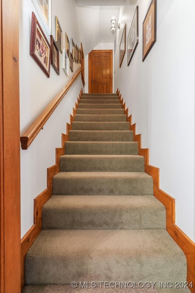 staircase featuring vaulted ceiling