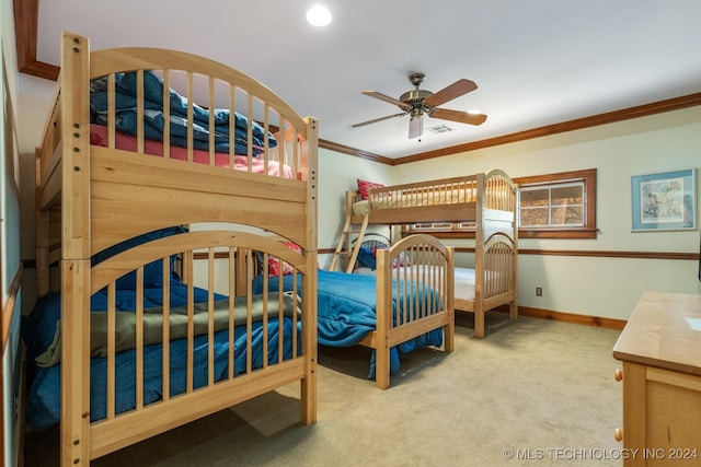 carpeted bedroom featuring ornamental molding and ceiling fan