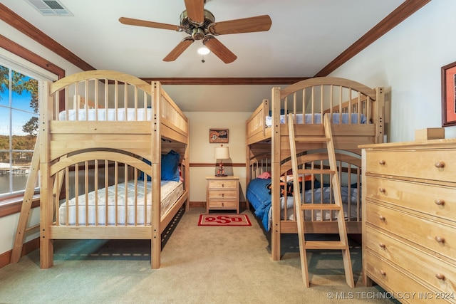 bedroom with ceiling fan, ornamental molding, and light colored carpet