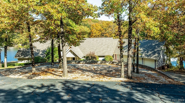 view of front facade featuring a garage and a water view