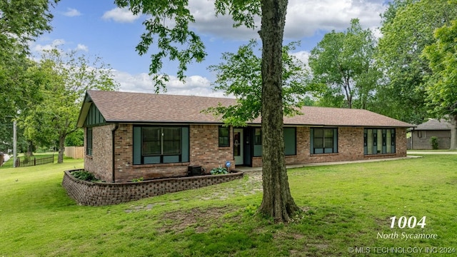 ranch-style home with a front lawn