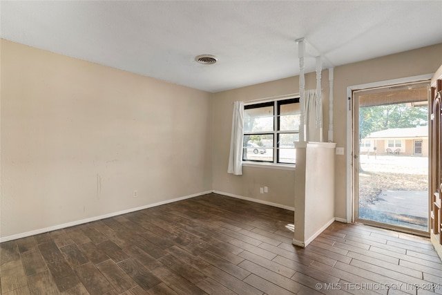 spare room with dark hardwood / wood-style floors