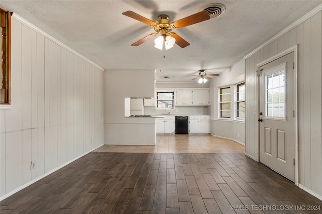 unfurnished living room featuring ornamental molding, hardwood / wood-style floors, and a textured ceiling