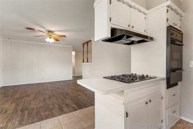 kitchen with light hardwood / wood-style floors, kitchen peninsula, stainless steel gas stovetop, and white cabinetry