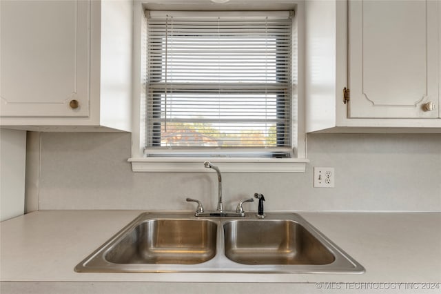 kitchen featuring sink and white cabinets