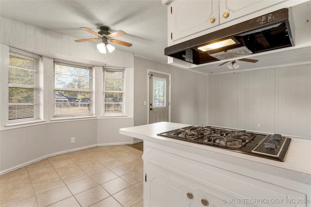 kitchen featuring white cabinets, light tile patterned flooring, and a wealth of natural light