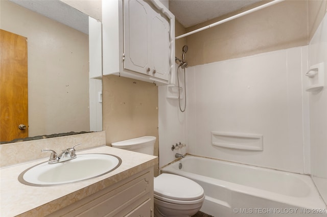 full bathroom featuring vanity, toilet, shower / bathing tub combination, and a textured ceiling