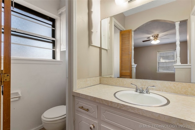 bathroom featuring vanity, toilet, and ceiling fan