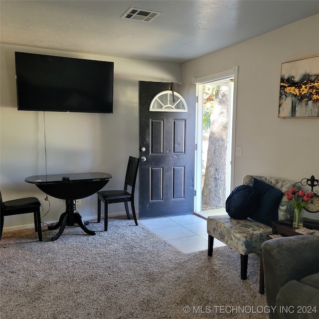 foyer entrance featuring light colored carpet