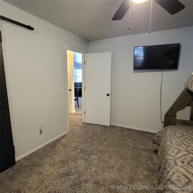 unfurnished bedroom featuring carpet flooring and ceiling fan