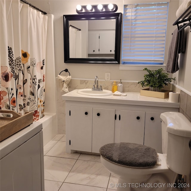 full bathroom with vanity, toilet, and shower / tub combo