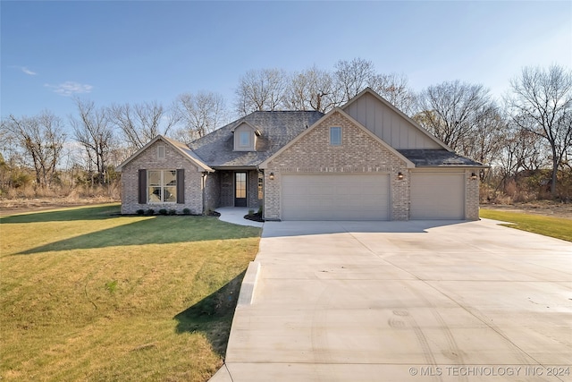 view of front facade with a garage and a front lawn