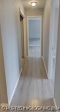 hallway with hardwood / wood-style floors