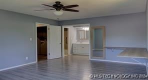 unfurnished bedroom featuring ceiling fan and dark hardwood / wood-style flooring