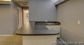 kitchen featuring sink and white cabinets