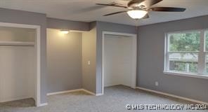 unfurnished bedroom featuring light carpet and ceiling fan