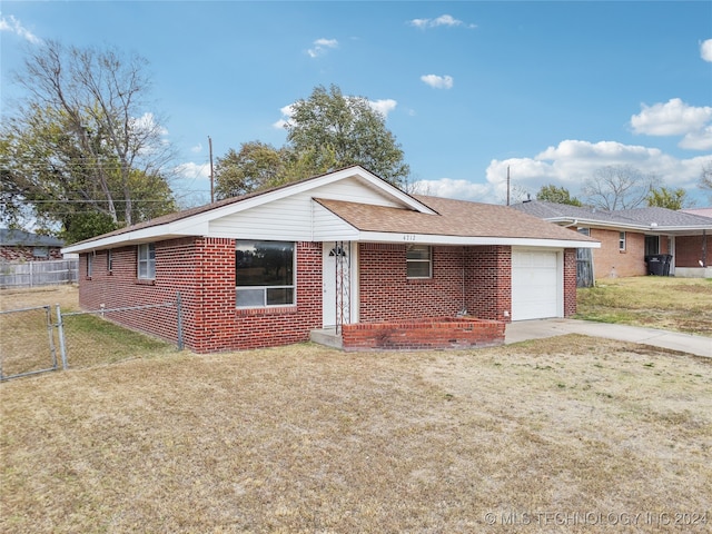 ranch-style home with a front yard and a garage