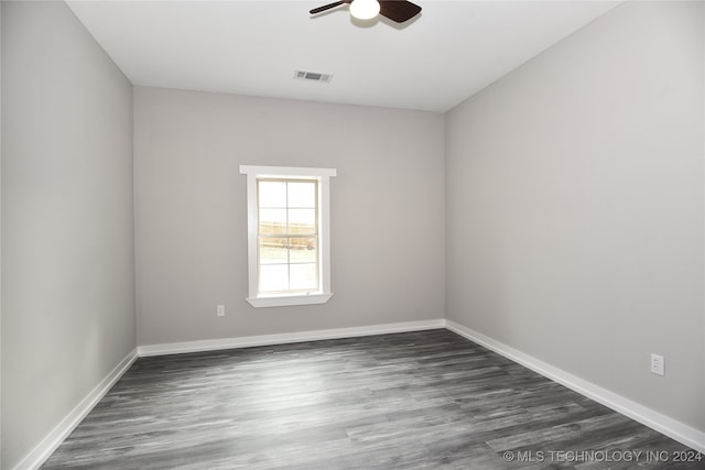 empty room with dark hardwood / wood-style floors and ceiling fan