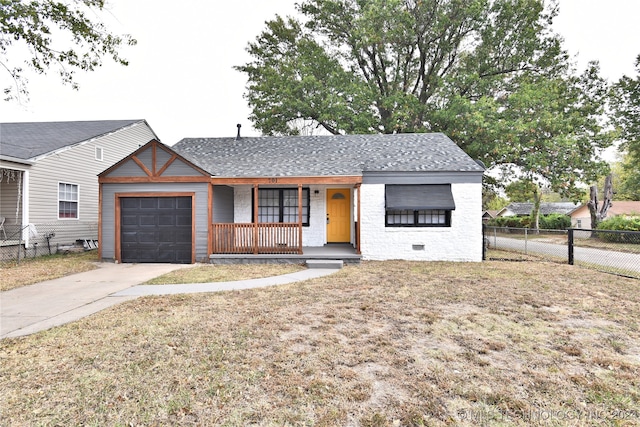 view of front of property featuring a porch, a front lawn, and a garage