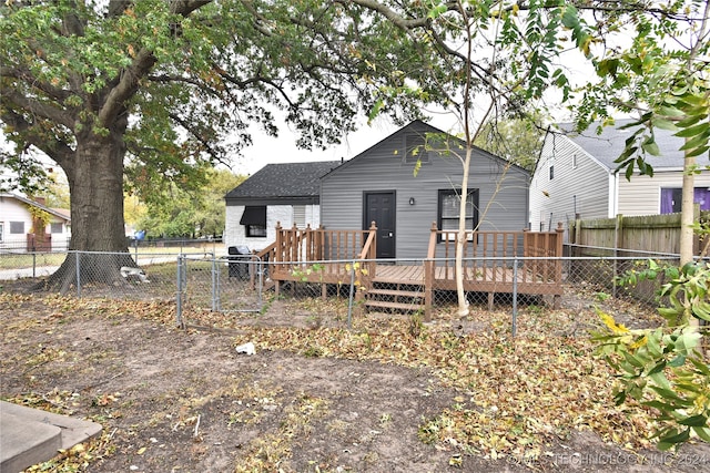 back of house with a wooden deck