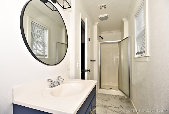 bathroom featuring vanity, crown molding, and a shower with shower door