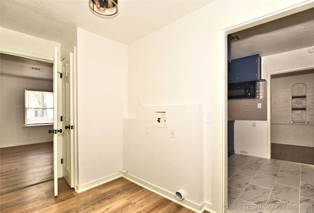 washroom featuring hardwood / wood-style flooring and washer hookup