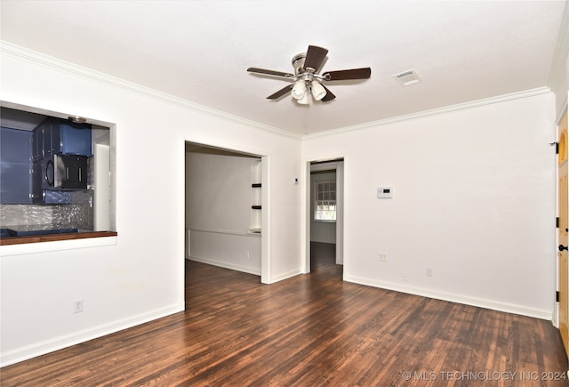 spare room with crown molding, dark hardwood / wood-style floors, and ceiling fan