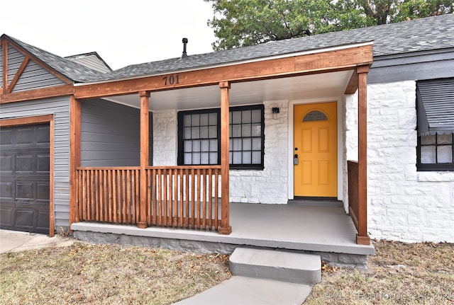 doorway to property with a porch and a garage