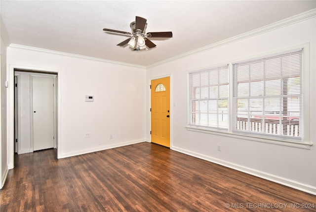 empty room featuring crown molding, dark hardwood / wood-style floors, and ceiling fan