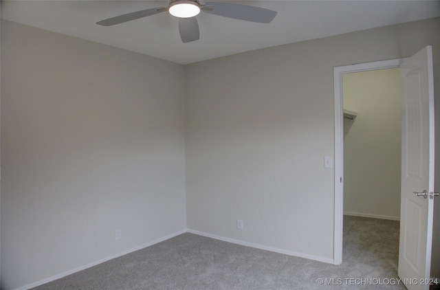 spare room with light colored carpet and ceiling fan