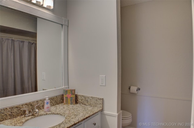 bathroom featuring vanity and toilet