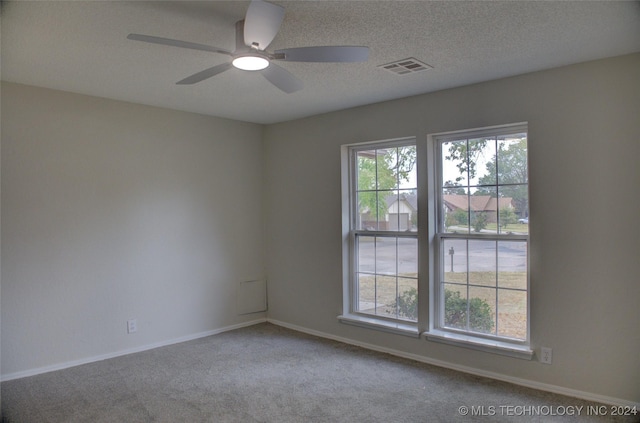 unfurnished room with carpet and ceiling fan