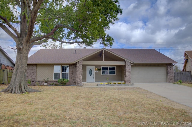 single story home featuring a garage and a front yard